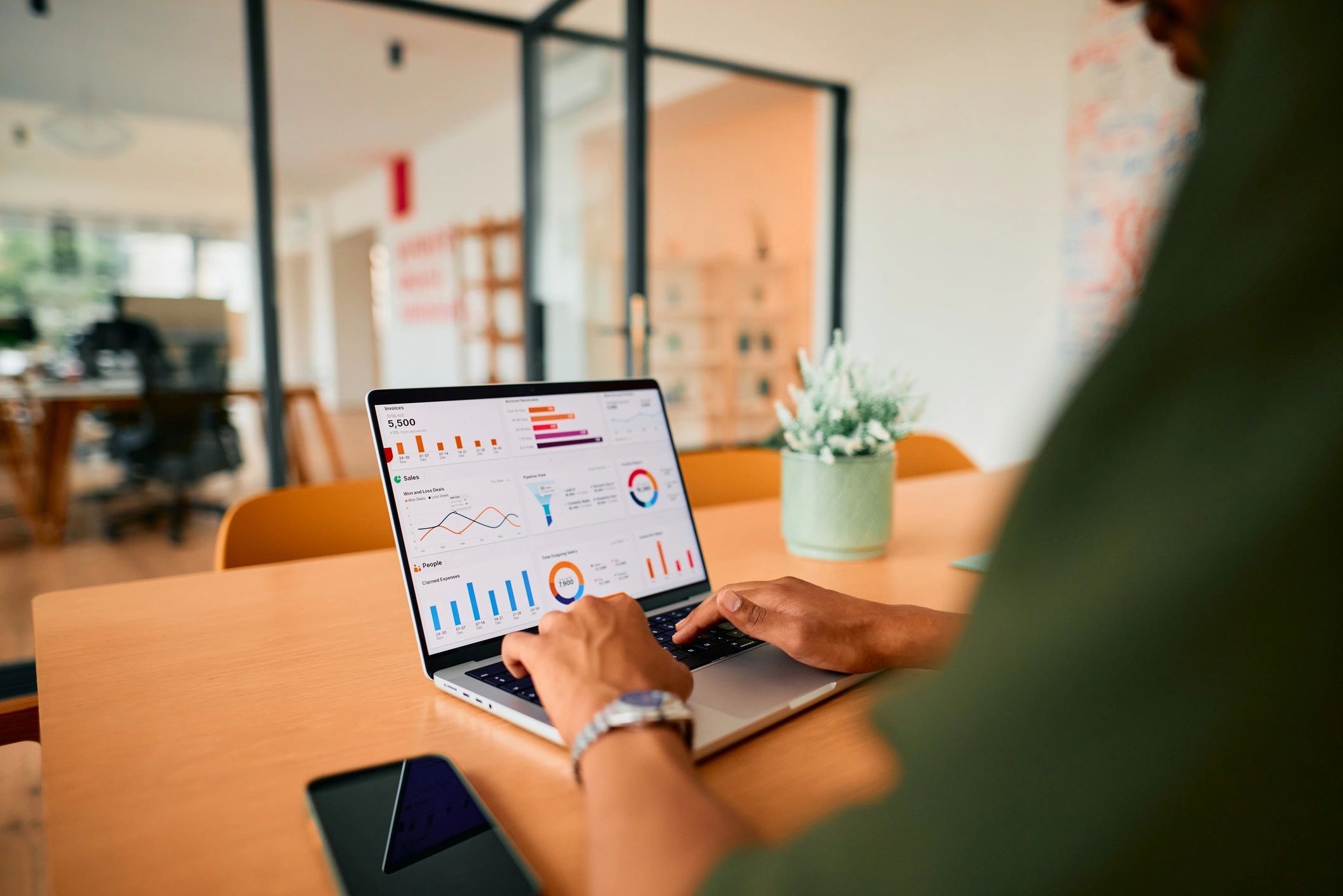 Professional reviewing campaign performance data on a laptop